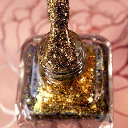 Top-angled, close-up of opened Kiss Nail Lacquer bottle with the brush showing. Emphasizes chunky gold flakes.