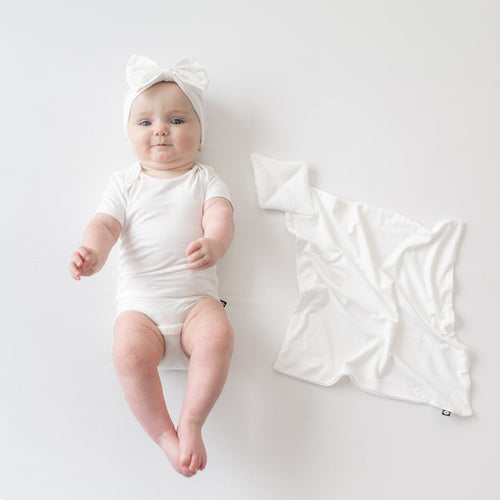 Baby wearing Bow Headband in Cloud  next to Cloud Kite Lovey