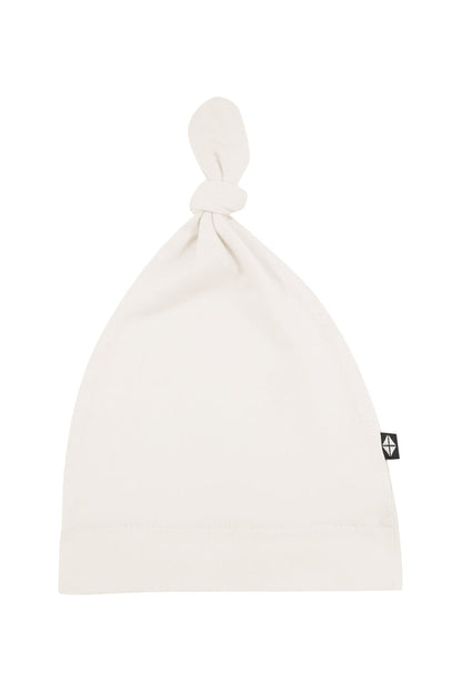 Flat lay of Kyte Baby Knotted Cap in Oat