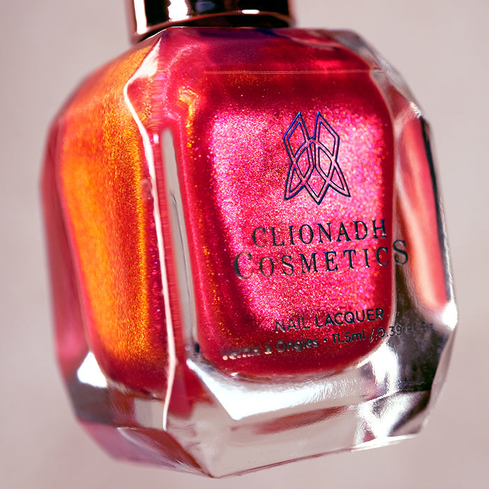Close-up, angled shot of La Vie En Rose Nail Lacquer bottle on a beige background.