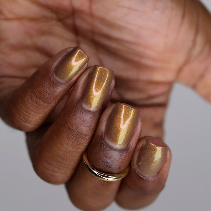 Upside down, close-up of nails painted with Lattes and Cider Nail Lacquer on deep skin tone.