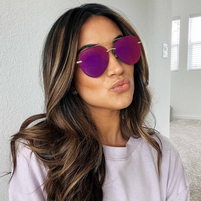 UGC - lifestyle - female wearing diff eyewear lenox aviator sunglasses with a gold metal frame and sunset mirror polarized lenses front view
