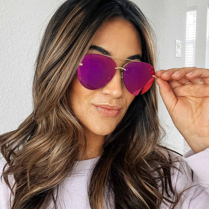 UGC - lifestyle - close up of female wearing diff eyewear lenox aviator sunglasses with a gold metal frame and sunset mirror polarized lenses front view
