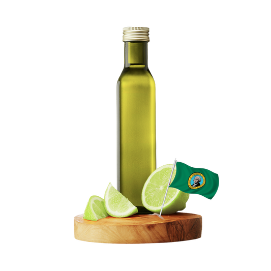 A tall olive-green glass bottle with a silver cap stands on a round wooden board with several green lime wedges and a small Washington flag.