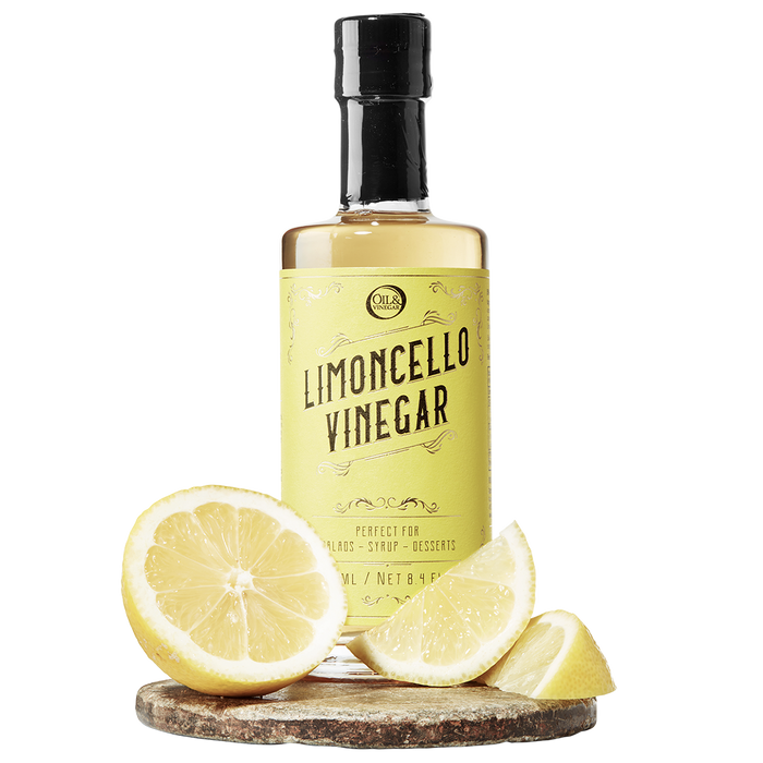 A bottle labeled 'LIMONCELLO VINEGAR' with a lemon and lemon slices in front of the bottle.