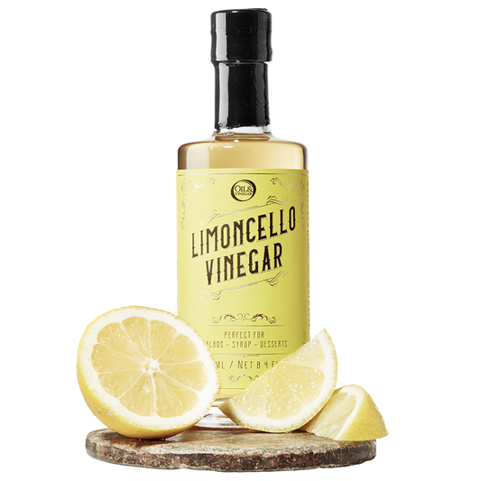 A bottle labeled 'LIMONCELLO VINEGAR' with a lemon and lemon slices in front of the bottle.