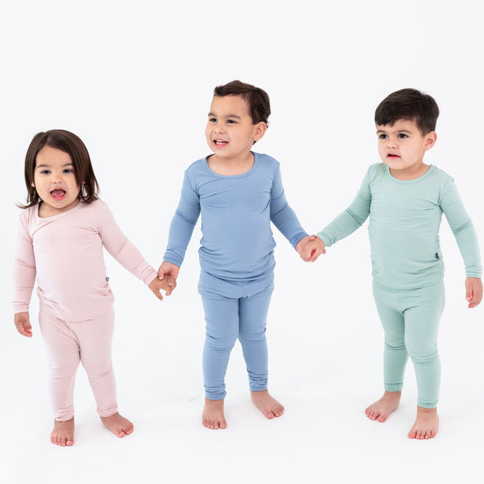 Toddlers holding hands while wearing Long Sleeve Pajama Sets in Blush, Slate and Sage