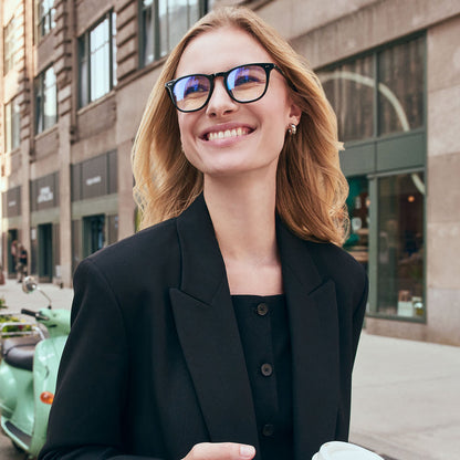 on model - female in new york city wearing Maxwell black and blue light technology glasses