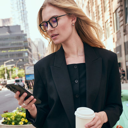 on model - female in new york city wearing Maxwell black and blue light technology glasses