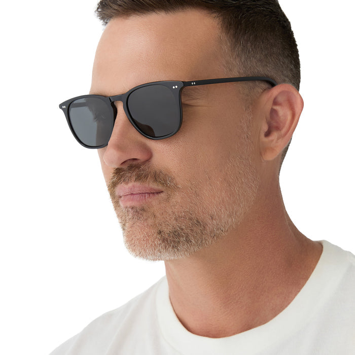 on model - male wearing diff eyewear maxwell extra large square sunglasses in a black frame and solid grey polarized lens angled view