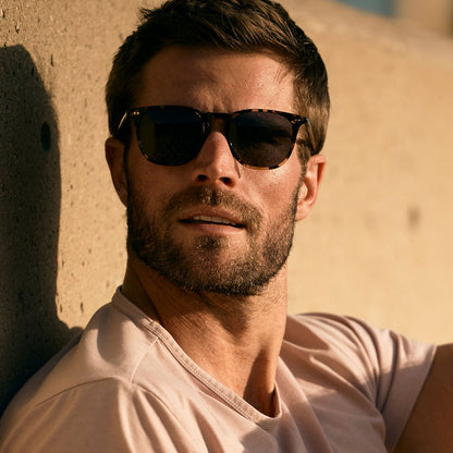 lifestyle - male wearing (davey fisher) diff eyewear maxwell xl square sunglasses with a espresso tortoise frame and grey polarized lenses front view