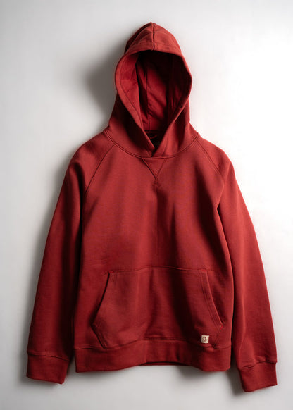 Red hoodie with a front pocket and hood, displayed against a plain white background. Simple and casual design.