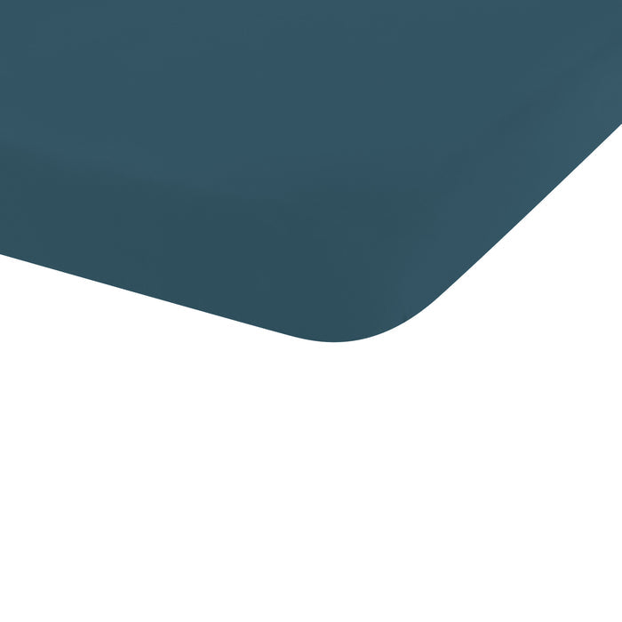 The corner of the Mini Crib Sheet in Atlantic shown on a mini crib mattress