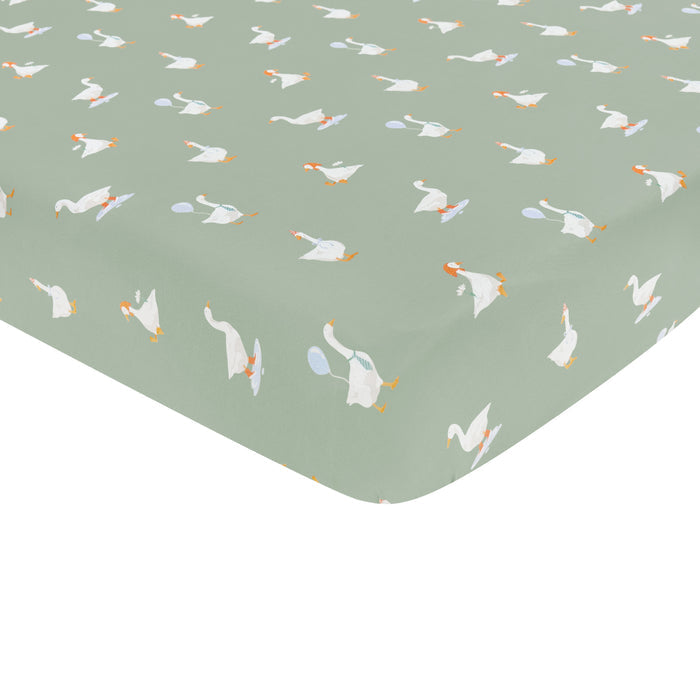 Corner of the Mini Crib Sheet in Silly Goose shown on a mini crib mattress