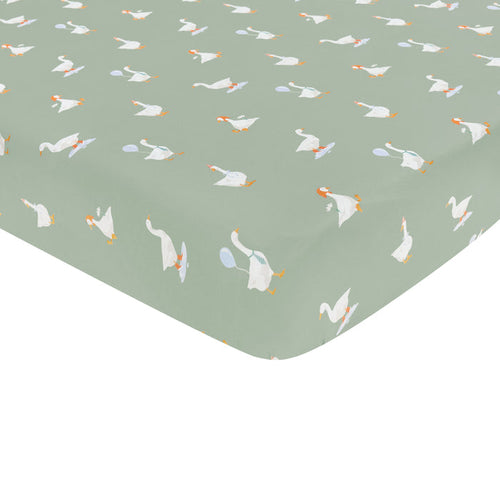 Corner of the Mini Crib Sheet in Silly Goose shown on a mini crib mattress