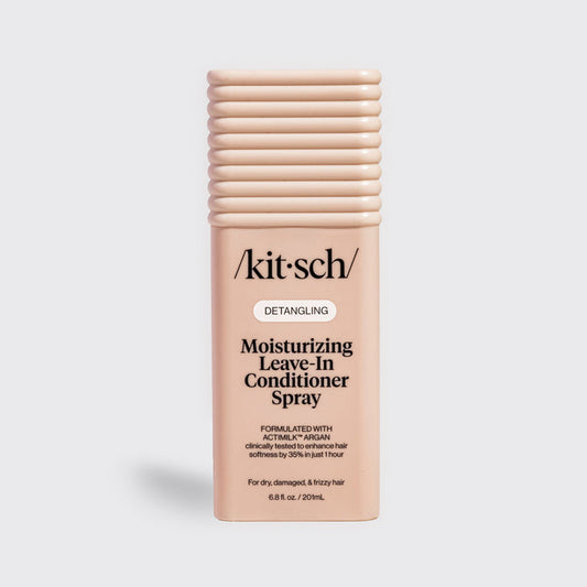 Kitsch Moisturizing Leave-In Conditioner Spray in blush packaging for dry, damaged, and frizzy hair, formulated with Actimilk™ Argan.