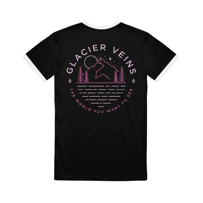 Back of black short sleeve shirt with GLACIER VEINS written across the top. Below the text is a drawing of a mountain with a moon over it and stars in the sky. there are pine trees at the base of the mountain. Below the drawing is pink text that says THE WORLD YOU WANT TO SEE.