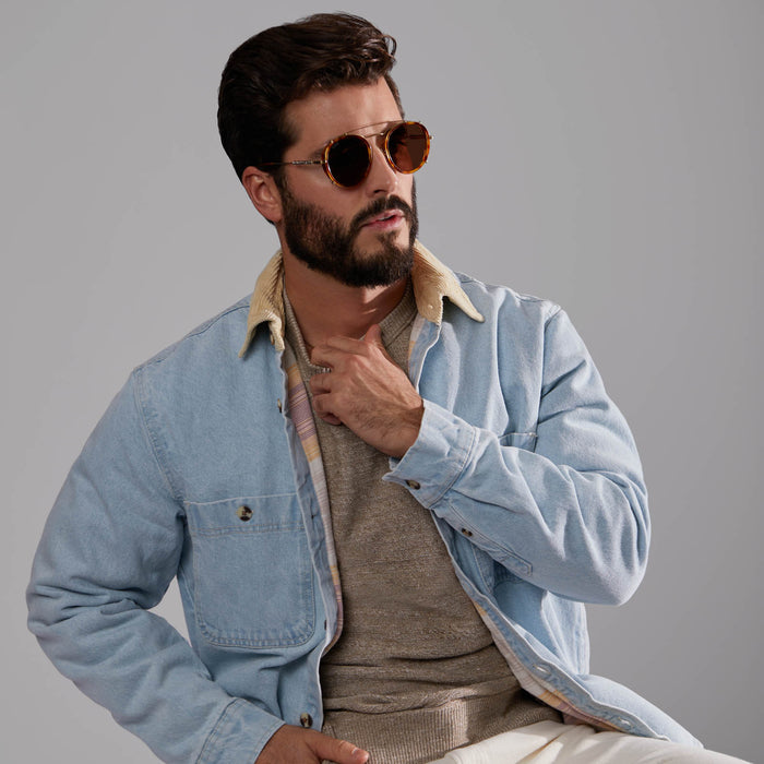 lifestyle - male model seated wearing star wars x diff eyewear obi-wan sunglasses with a desert tortoise frame and brown polarized lenses