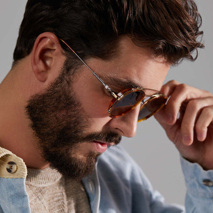 lifestyle - male model looking down wearing star wars x diff eyewear obi-wan sunglasses with a desert tortoise frame and brown polarized lenses