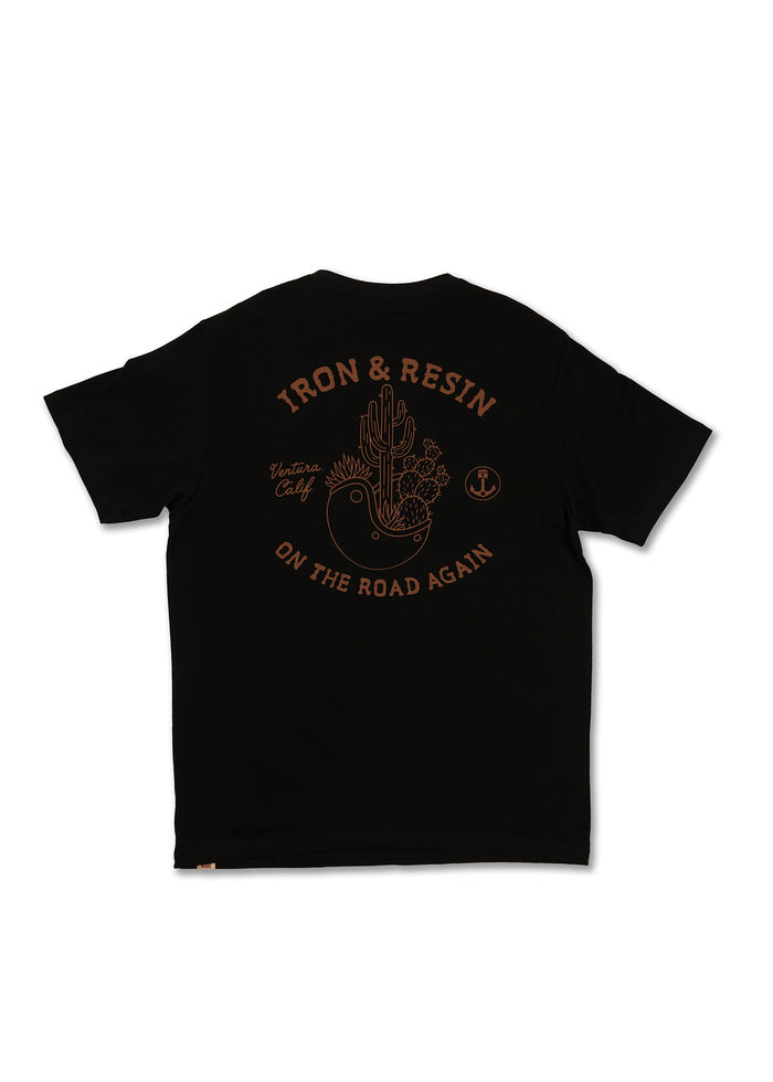 Black T-shirt with "Iron & Resin" logo, cactus design, and "On the Road Again" text in brown. Ventura, Calif. branding.