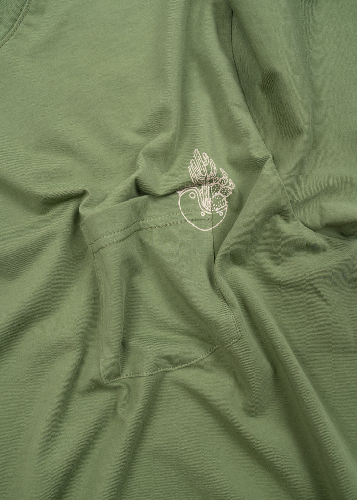 Green shirt with a small pocket and a white cactus design on the fabric, showcasing a simple and casual style.