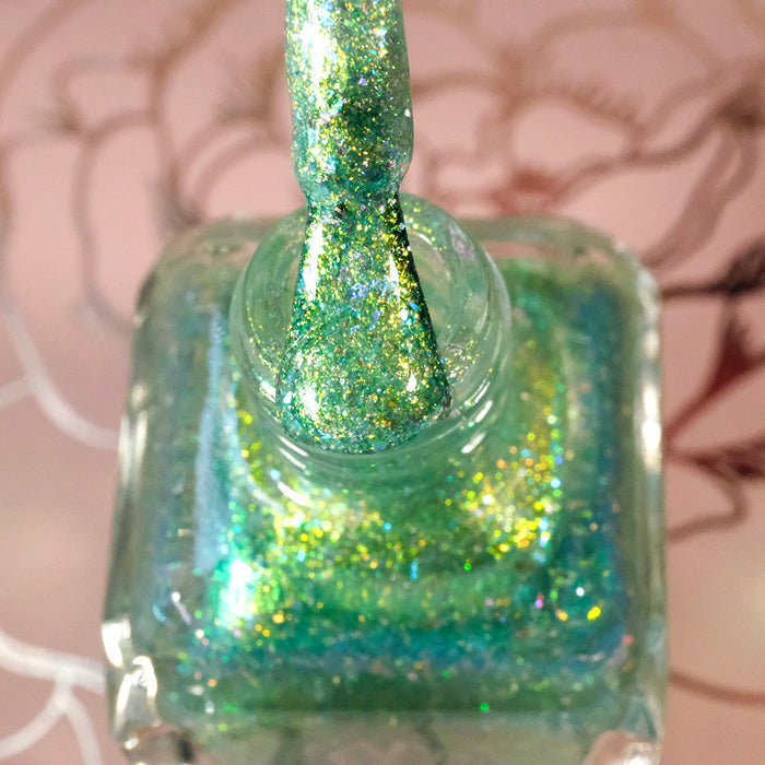 Top-angled, close-up of opened Ophelia Nail Lacquer bottle with the brush showing.