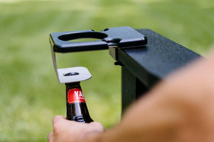 An image of a person opening a bottle using the Outrig cupholder