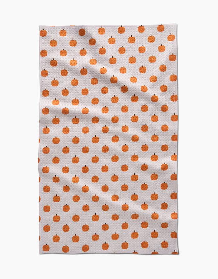 Tea towel with orange pumpkin pattern on a white background