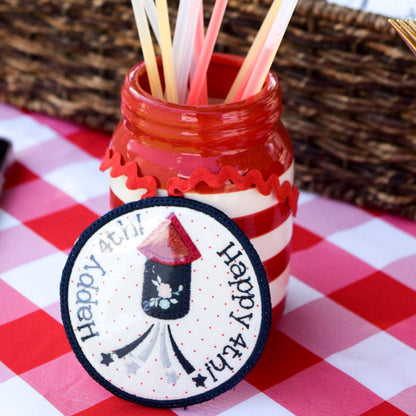 Red and white striped jar with straws on a checkered tablecloth, with Lay's potato chips in the background.