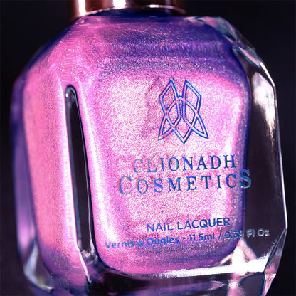 Close-up, angled shot of P.B. and Holo Nail Lacquer bottle on a black background.