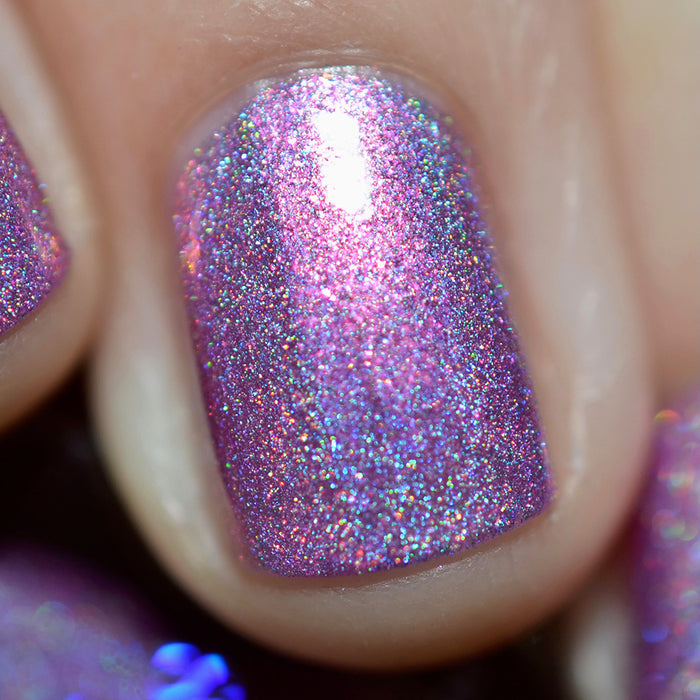 Close-up of one nail painted with P.B. & Holo Nail Lacquer on fair skin tone.