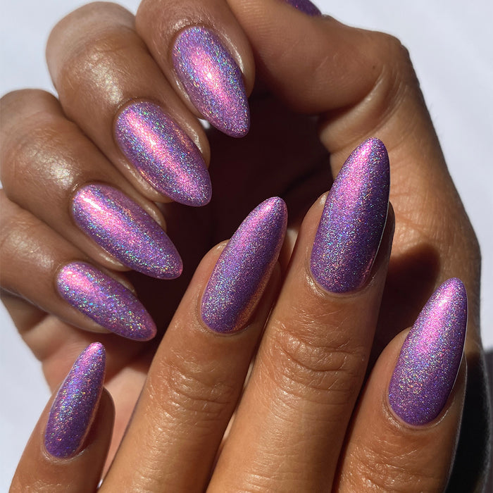 Close-up of nails painted with P.B. & Holo Nail Lacquer on medium skin tone.