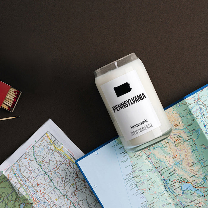 An overhead shot of the Pennsylvania candle that is overlayed on road maps.