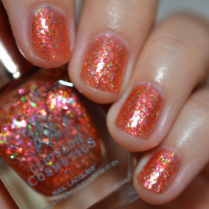 Close-up of nails painted with Autumn Acres Nail Lacquer on fair skin tone. Hand is holding polish bottle.