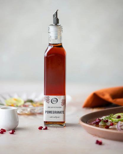 Bottle of pomegranate vinegar on a table with a blurred background