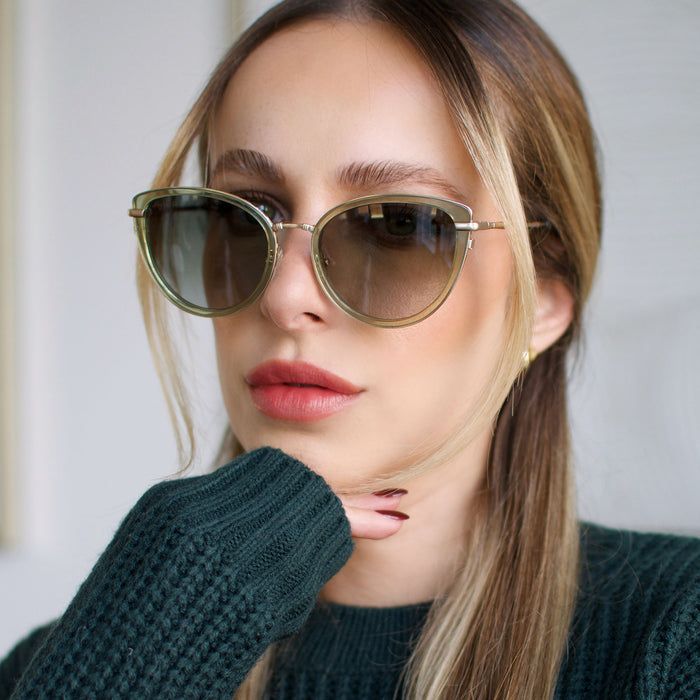 lifestyle - larissa.montana wearing star wars x diff eyewear princess leia™ endor™ cat eye sunglasses with a transulucent sage green acetate and gold metal frame with endor forest moon green polarized lenses front view