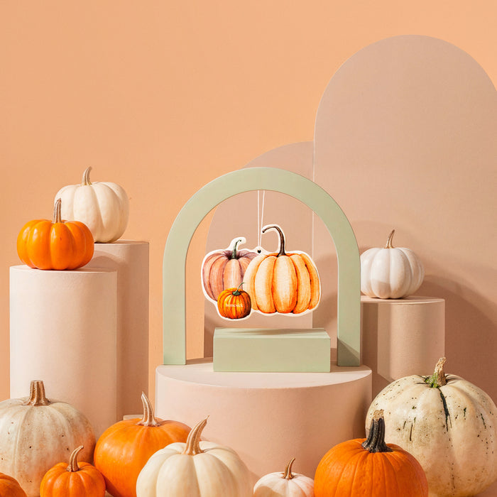 Car freshener on a stylized background with various pumpkins