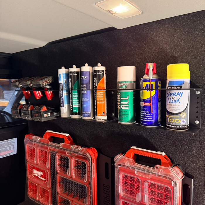 Collection of spray cans and toolboxes on a black shelf