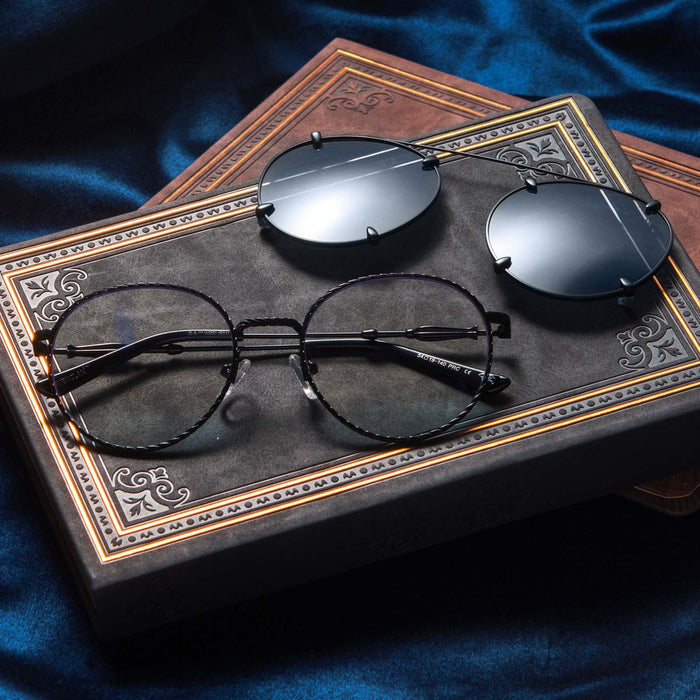 Flat-lay of Harry Potter x DIFF Ravenclaw glasses and sunglasses lying folded on top of books