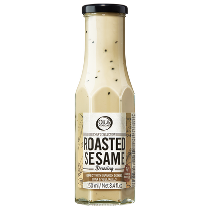 A bottle of Roasted Sesame Dressing with visible sesame seeds throughout the dressing.