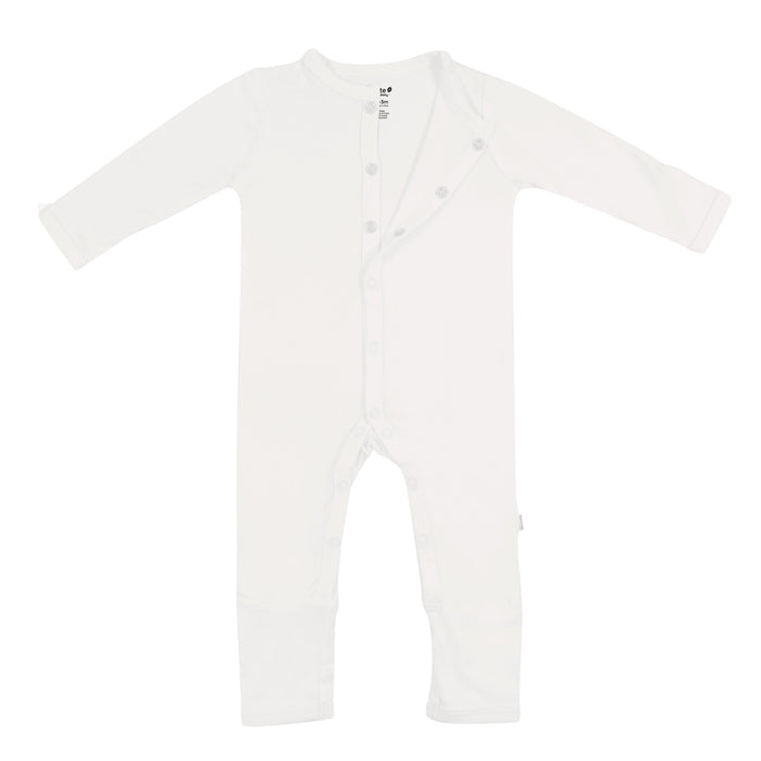 Flat lay of Kyte Baby long sleeve Romper in Cloud with top snaps opened