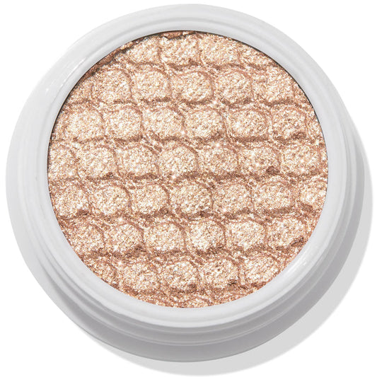 ColourPop Sailor Super Shock Shadow glitters in a close-up, a champagne-beige cream eyeshadow with a honeycomb quilted texture, seated in a white round pot on a clean white background, showcasing its metallic shimmer finish.