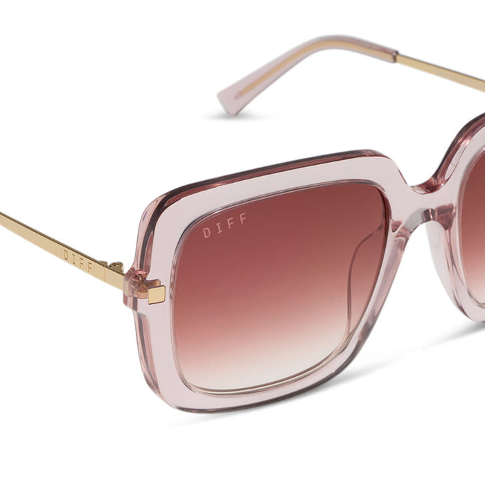 diff eyewear sandra square sunglasses with a light pink crystal frame and peach dusk gradient lenses detailed view