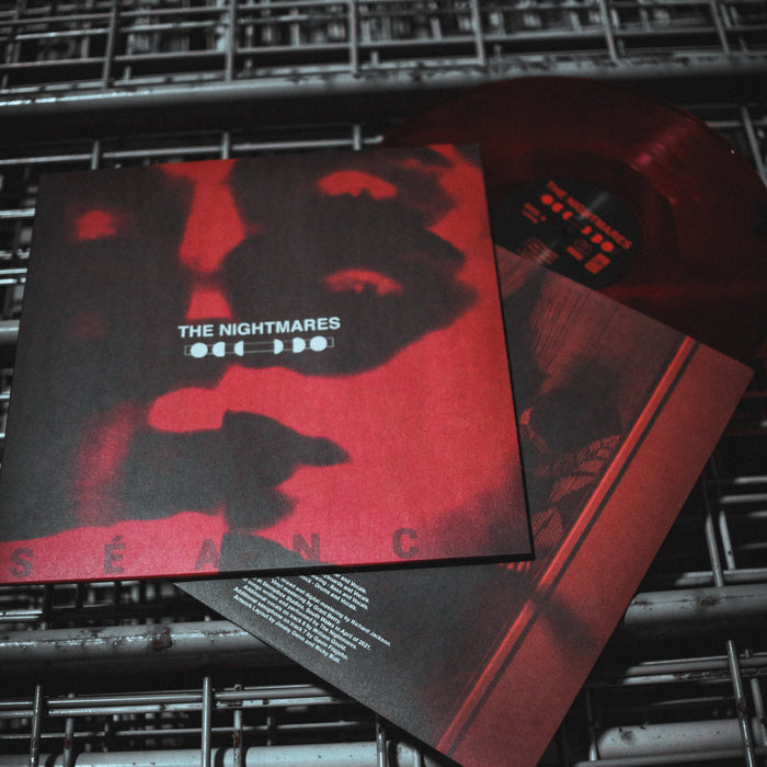 A limited edition THE NIGHTMARES - SÉANCE album features a Blood Red Black Smoke LP with a red transparent disc, a cover with a blurred red and black face, and the title in bold white text across the center.