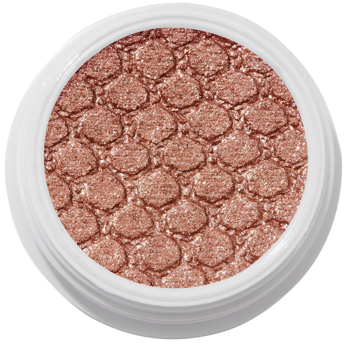 ColourPop Sequin Super Shock Shadow shimmers in metallic copper rose-gold as it catches light, pressed with a scale-embossed texture in a white round pot, shown in a clean studio overhead close-up.