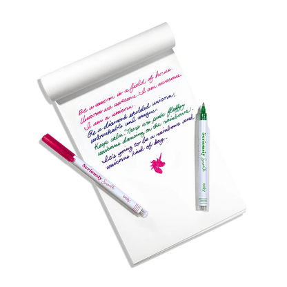 Written, colored notes with a pink and green OOLY Seriously Smooth Rollerball Gel Pens on a white paper sketchbook