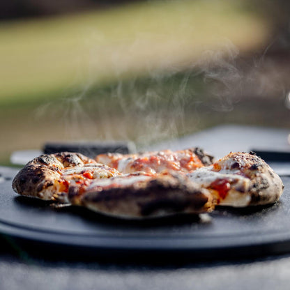 This is an image of fresh baked pizza served on thethe Breeo Serving Board