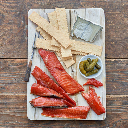 Sockeye Salmon Candy Strips served with crackers, pickles, and cheese