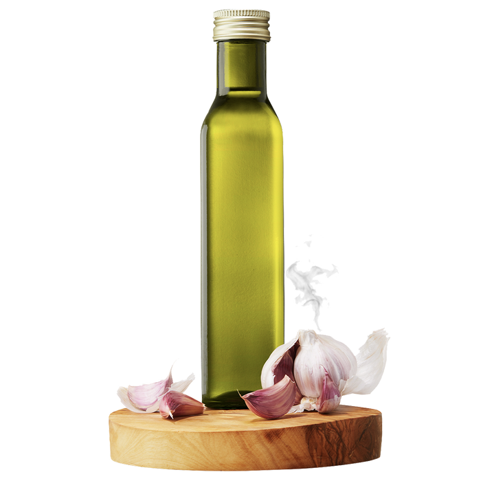 A bottle of Smoky Garlic Grapeseed Oil displayed on a wooden platform with whole garlic cloves and sliced garlic nearby.