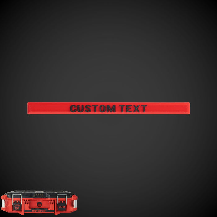 A custom text label in red on a black background, designed to clip onto a tool box handle.
